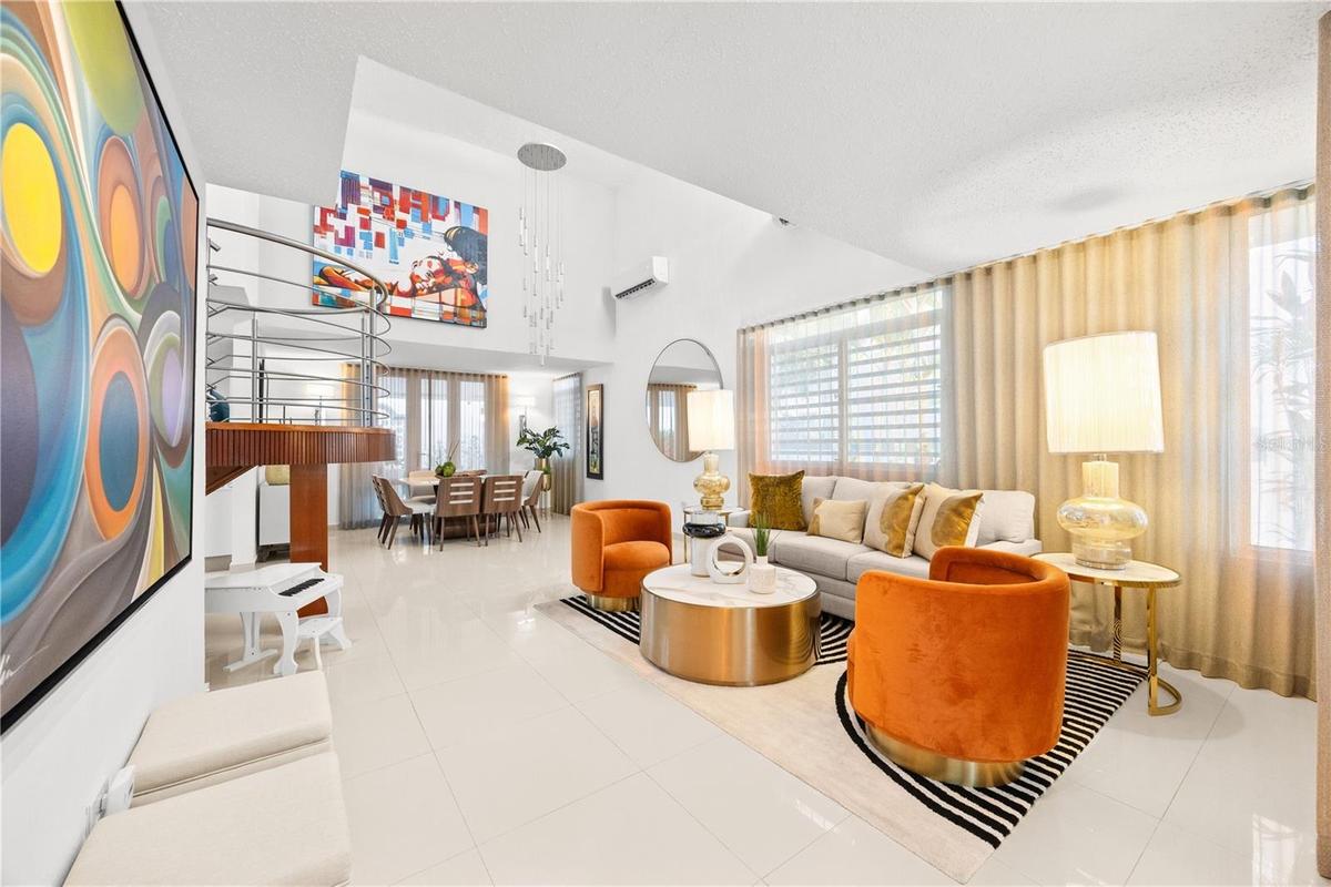 Open living and dining areas with double height ceilings and sweeping sightlines