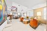 Open living and dining areas with double height ceilings and sweeping sightlines