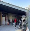 Over 250 SF of additional exterior covered work space-with breezeway roll up door in the back of area