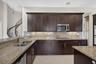 Kitchen features under and over counter lighting, crown ,moldings, double oven and SS appliances