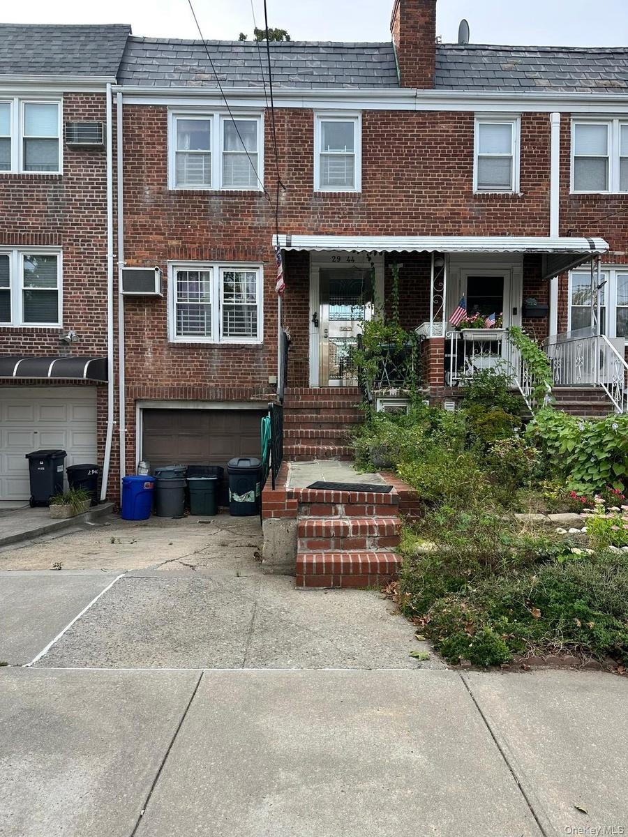 Front view of the home with driveway ,and landscaped entrance