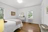 Bedroom #2 of 3, with hardwood floors and closet.