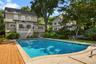 View over looking pool towards back of house.
