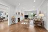 Living room has front to back windows, hardwood flooring and recessed lighting.