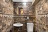 A marble-clad powder room adds a refined touch.