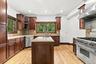 Granite, cherry cabinetry and high-end appliances come together beautifully.