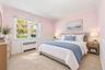 Carpeted flooring with painted walls, a window, and white wainscoting