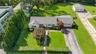 Single-story residence with a two-car garage, mature landscaping, and an additional detached two-car garage