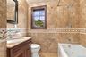 High-end finishes elevate the accessory apartment bath.