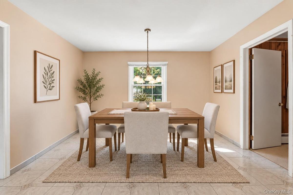 **Virtually Staged** Recessed window with exterior views, overhead chandelier, and light-toned tile flooring