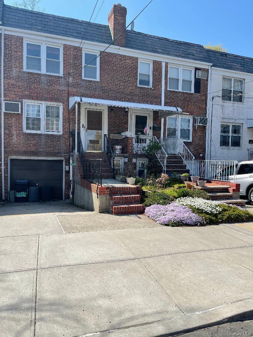 Front view of the home with driveway ,and landscaped entrance