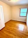 Spare room with a baseboard heating unit and light wood-type flooring