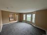 Spare room featuring baseboards and carpet floors