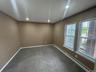 Carpeted spare room with baseboards, recessed lighting, and a baseboard radiator