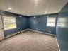 Empty room featuring baseboards, carpet flooring, plenty of natural light, and a baseboard radiator