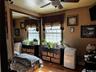 Wood-finish flooring with a ceiling fan overhead