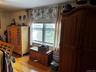 Hardwood flooring, window with sash detail, and baseboard heating