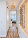 HALLWAY TO THE PRIMARY SUITE EAST- BEAUTIFUL ART THROUGHOUT