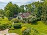 This home is situated on an acre of lush property. It is surrounding by mature trees and feels private and serene.