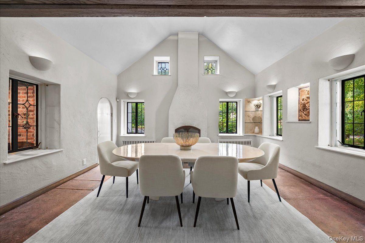 The dining room features a fireplace and beautiful inset artwork.