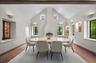 The dining room features a fireplace and beautiful inset artwork.