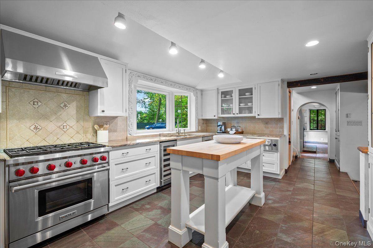 The kitchen features high end stainless appliances including a Subzero refrigerator and freezer and Wolf range.