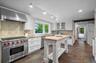 The kitchen features high end stainless appliances including a Subzero refrigerator and freezer and Wolf range.