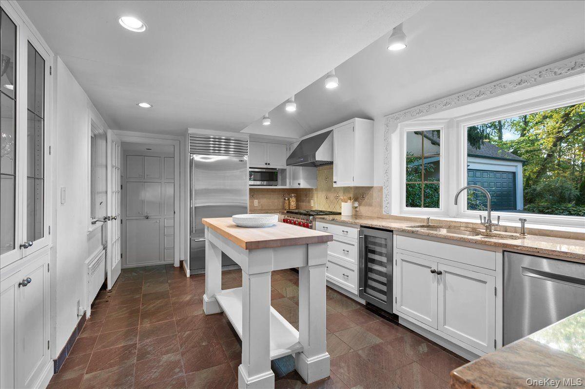 The kitchen opens onto the breakfast room and connects to the formal dining room; an ideal layout for entertaining.