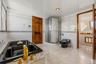 Bathroom with access to hall and second primary suite