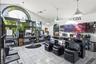 Tile flooring, multiple arched windows, vaulted ceilings, pendant lighting fixtures, and a dedicated shampoo station