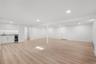 Finished basement with wet bar and engineered wood floors