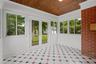 Tiled sunroom with new french doors to the deck and back yard