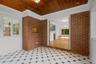 Tiled sunroom with entrance to the dining area