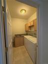 seperate laundry room, with sink, cabinetry and counters