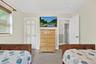 Neutral wall paint, built-in window with blinds, and white interior doors