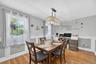Hardwood flooring throughout, with a recessed window and decorative wall paneling
