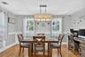 Hardwood flooring, recessed lighting, chair rail molding, multiple windows, and a ceiling-mounted light fixture