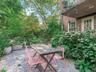 Garden landscaped with mature perennial plantings.