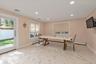 Ideal for entertaining with an open floor plan, crown molding, recessed lighting, and sliding glass doors to patio.