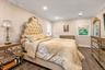 Bedroom #1Wood-finish flooring, recessed lighting, crown molding, and large walk-in closet with en-suite bath.