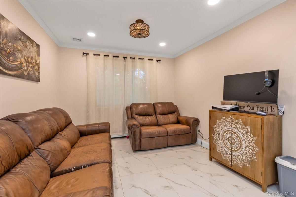 Recessed lighting, crown molding, and a porcelain floors throughout lower level