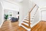 Stairs to second floor and front door entry