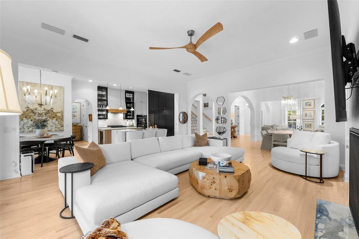 Open family room with ceiling fan, French doors to the lanai, and direct connection to the kitchen.