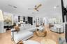 Open family room with ceiling fan, French doors to the lanai, and direct connection to the kitchen.