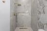 3rd Bathroom Walk-in shower with brass rain showerhead and wall niche.