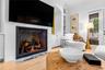 Fireplace with mounted TV and flanking built-in shelving.