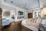 French doors, arched window, and linear electric fireplace.
