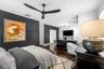 3rd Bedroom - Dark accent wall, ceiling fan, and window with plantation shutters.