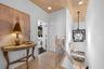 Upstairs landing — Vaulted wood plank ceiling, light wood flooring, and stair railing with lantern-style pendant.