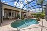 Pool — Free-form pool with paver surround and view of the covered lanai.